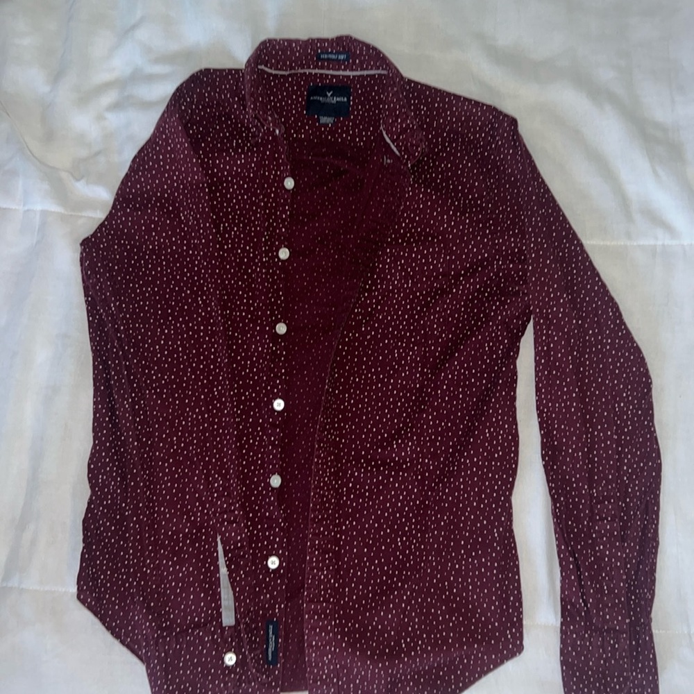 This is a men’s red full sleeve button up with white polka dots.